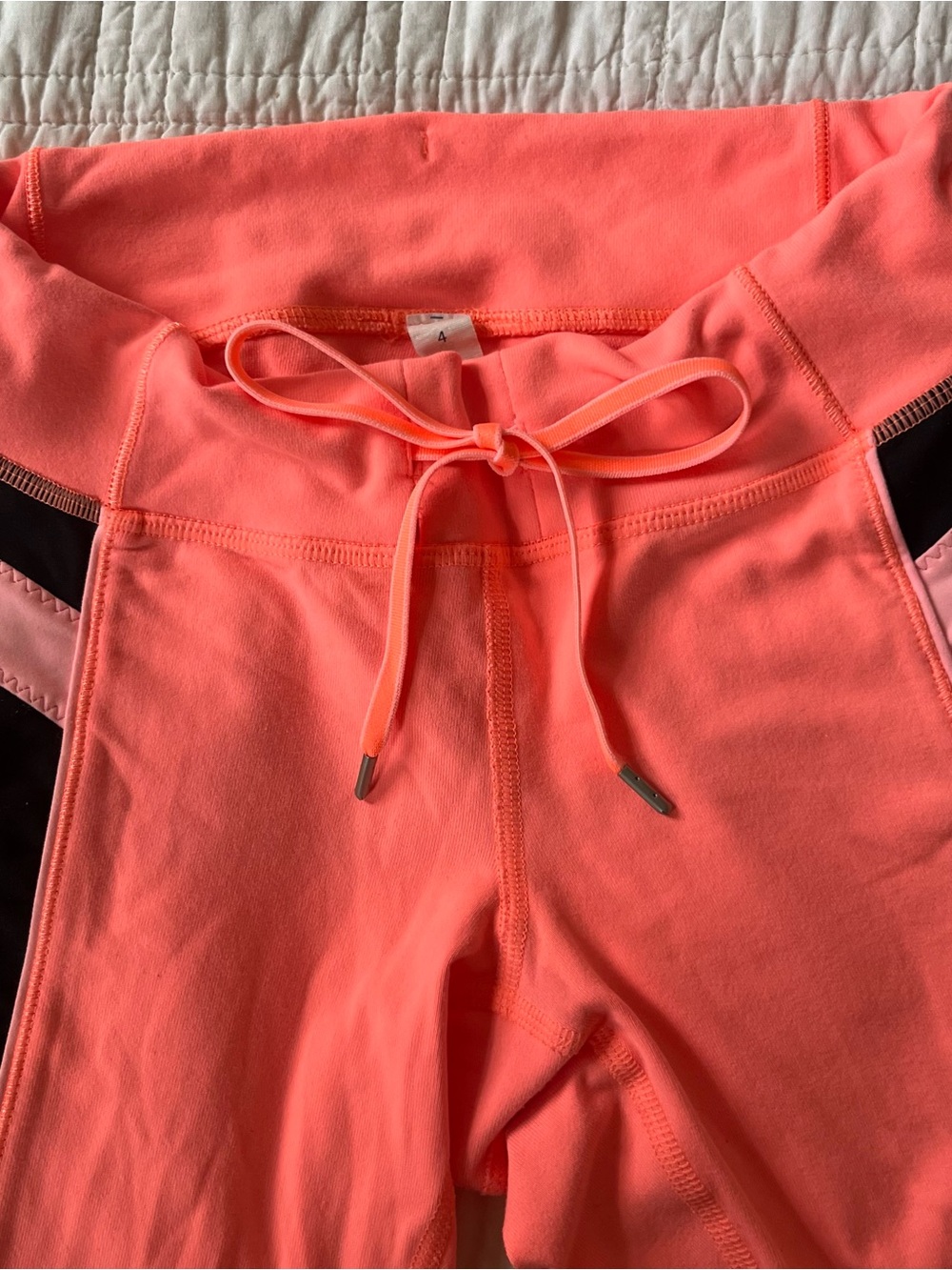 lululemon athletica capri leggings in Neon Coral & black